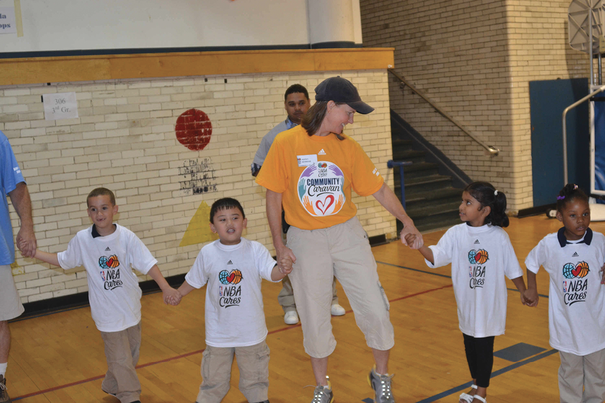 Kathy Behrens with young children at an NBA Cares event