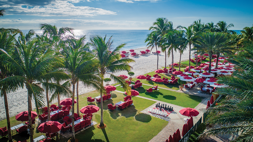 Acqualina’s signature red umbrellas on the resorts’ expansive beachfront